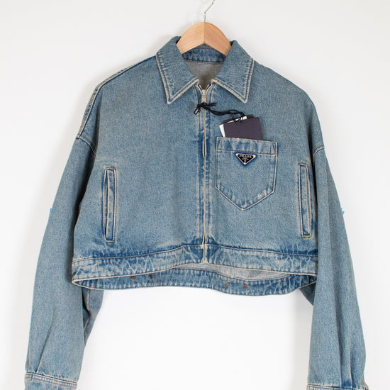 Denim jacket with a brand logo on a white background