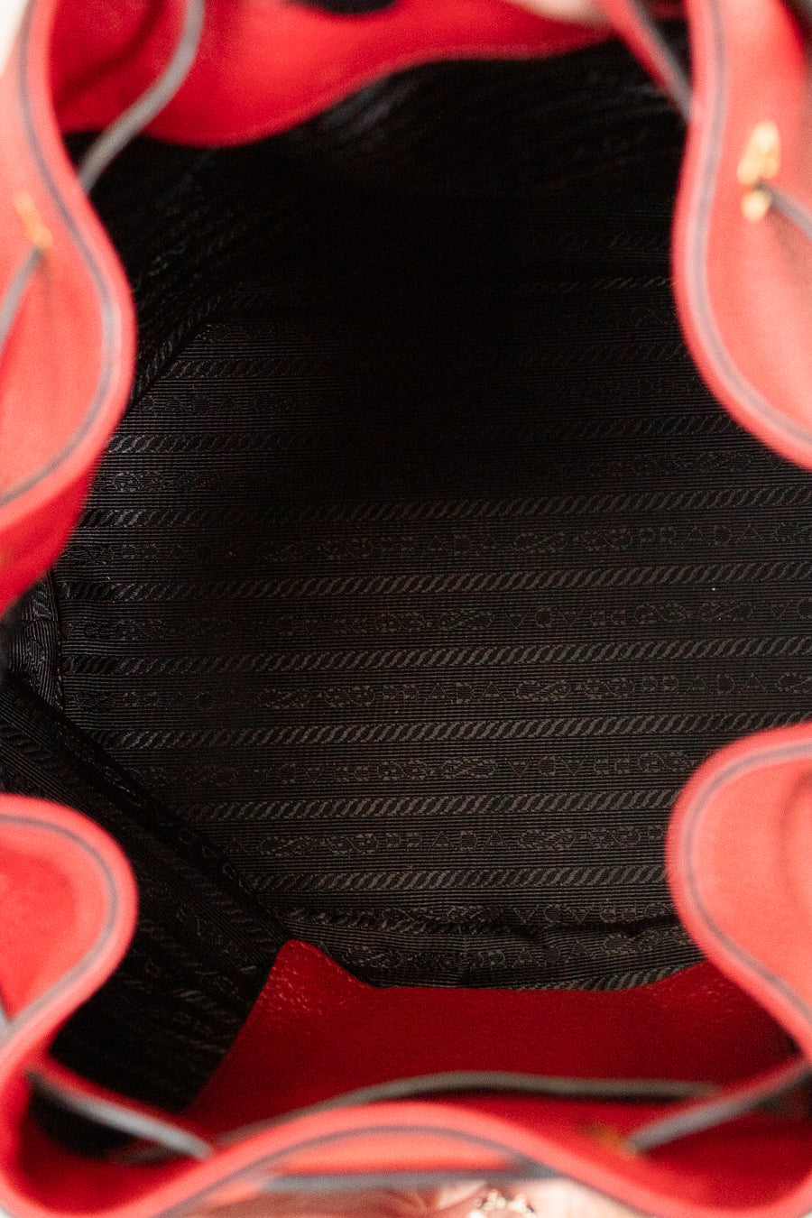 Close-up of a red handbag with a black interior