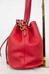 Red leather bucket bag with gold clasp on a white background