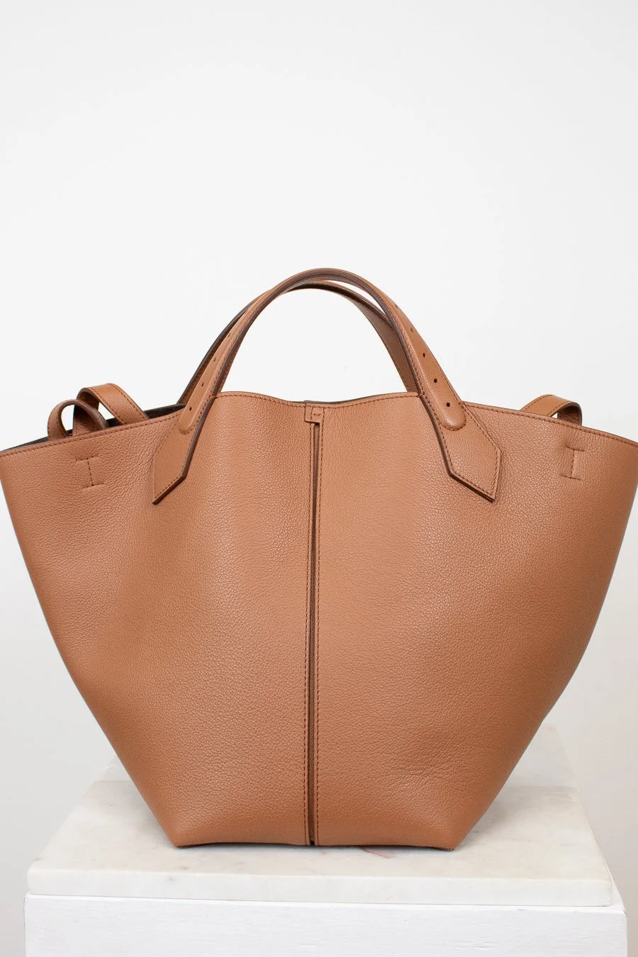 Brown leather tote bag on a white background