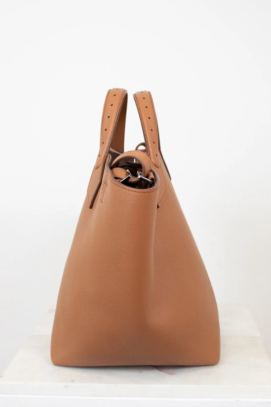 Brown leather handbag on a white background