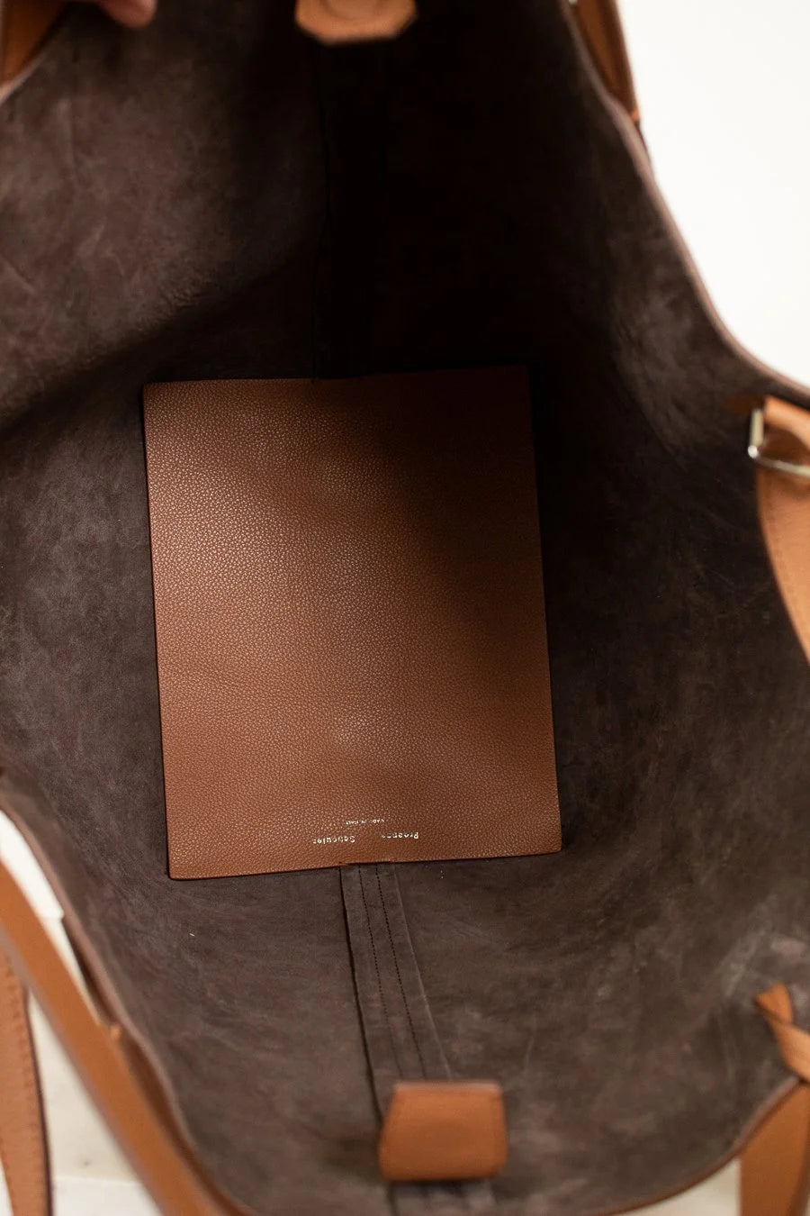 Brown leather bag interior with leather floor mat