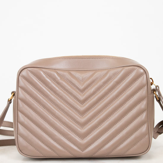 Beige quilted handbag on a white background