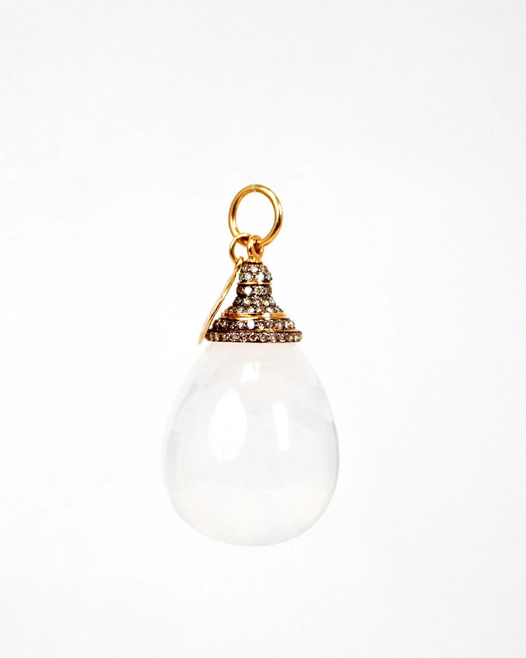 White teardrop-shaped pendant with gold and diamond accents on a white background