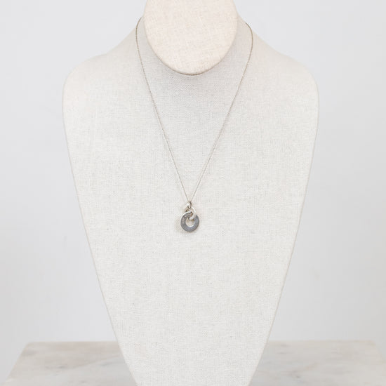 Necklace with a pendant on a mannequin bust against a white background