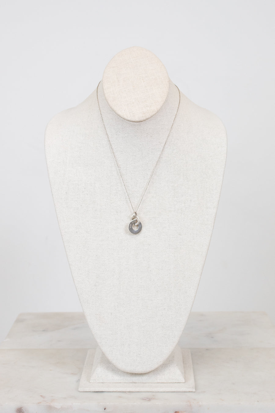 Necklace with a pendant on a mannequin bust against a white background