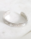 Silver bracelet with 'T&CO' engraving on a marble surface