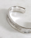 Silver ring with Tiffany & Co. engraving on a white marble surface