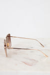 Gold-framed sunglasses on a marble surface