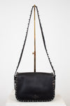 Black leather handbag with chain strap on a white background