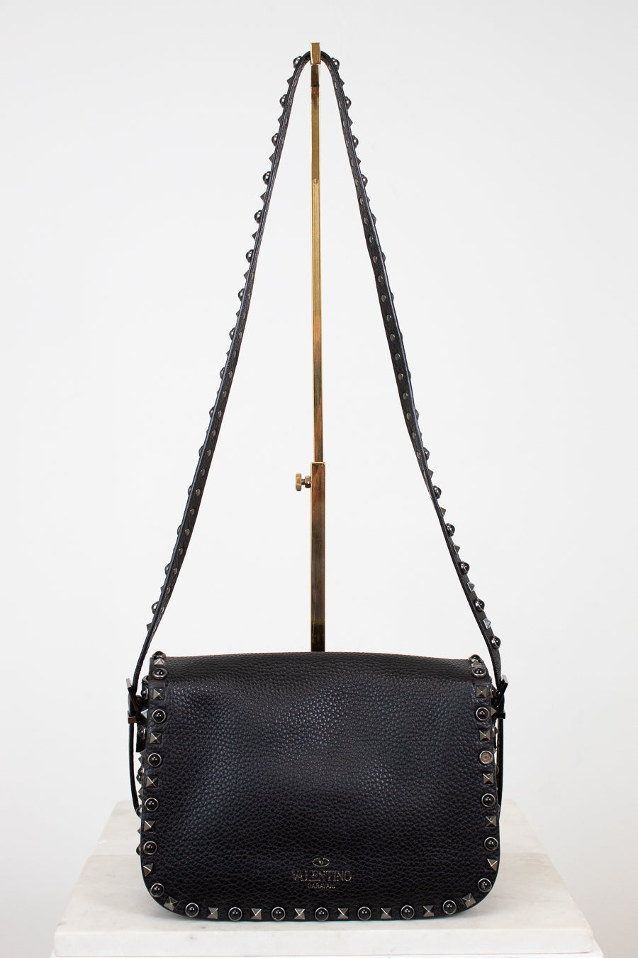 Black leather handbag with chain strap on a white background