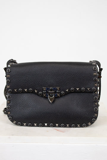Black leather purse with gunmetal hardware on white background