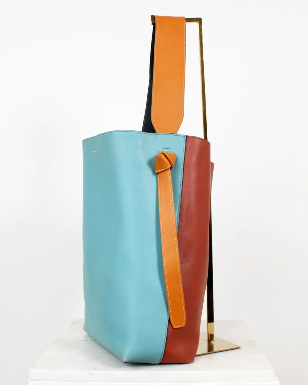 Colorful tote bag with a mix of blue, orange, and brown on a white background