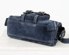 Blue leather bag with a strap on a white background