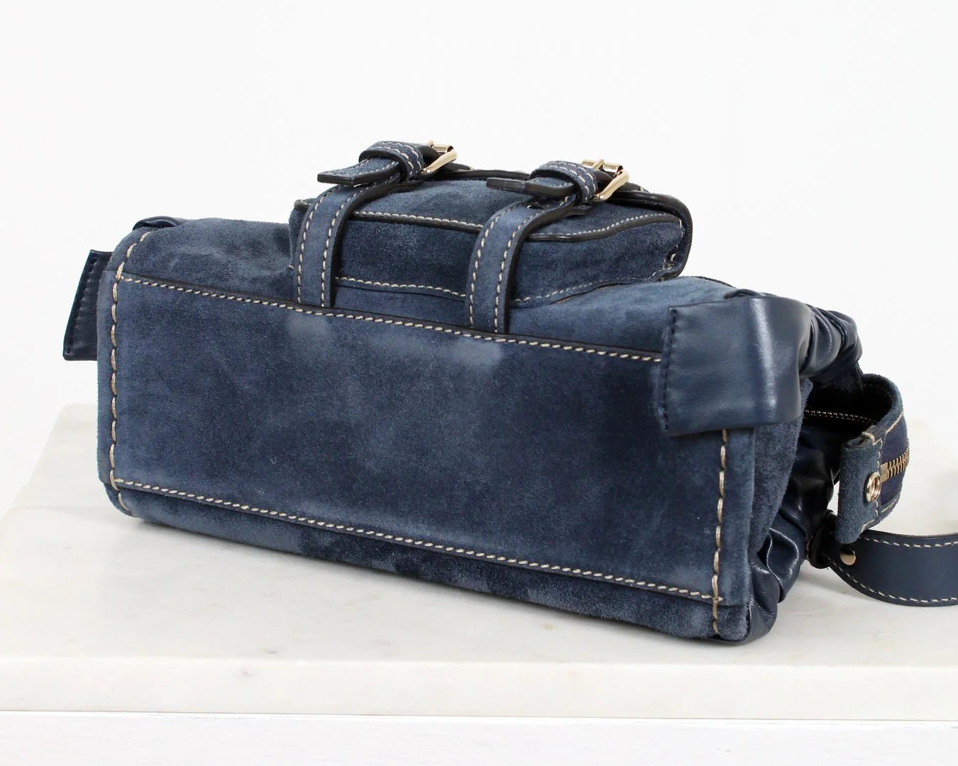Blue leather bag with a strap on a white background