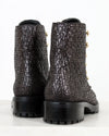 Pair of black and silver tweed boots on a white background