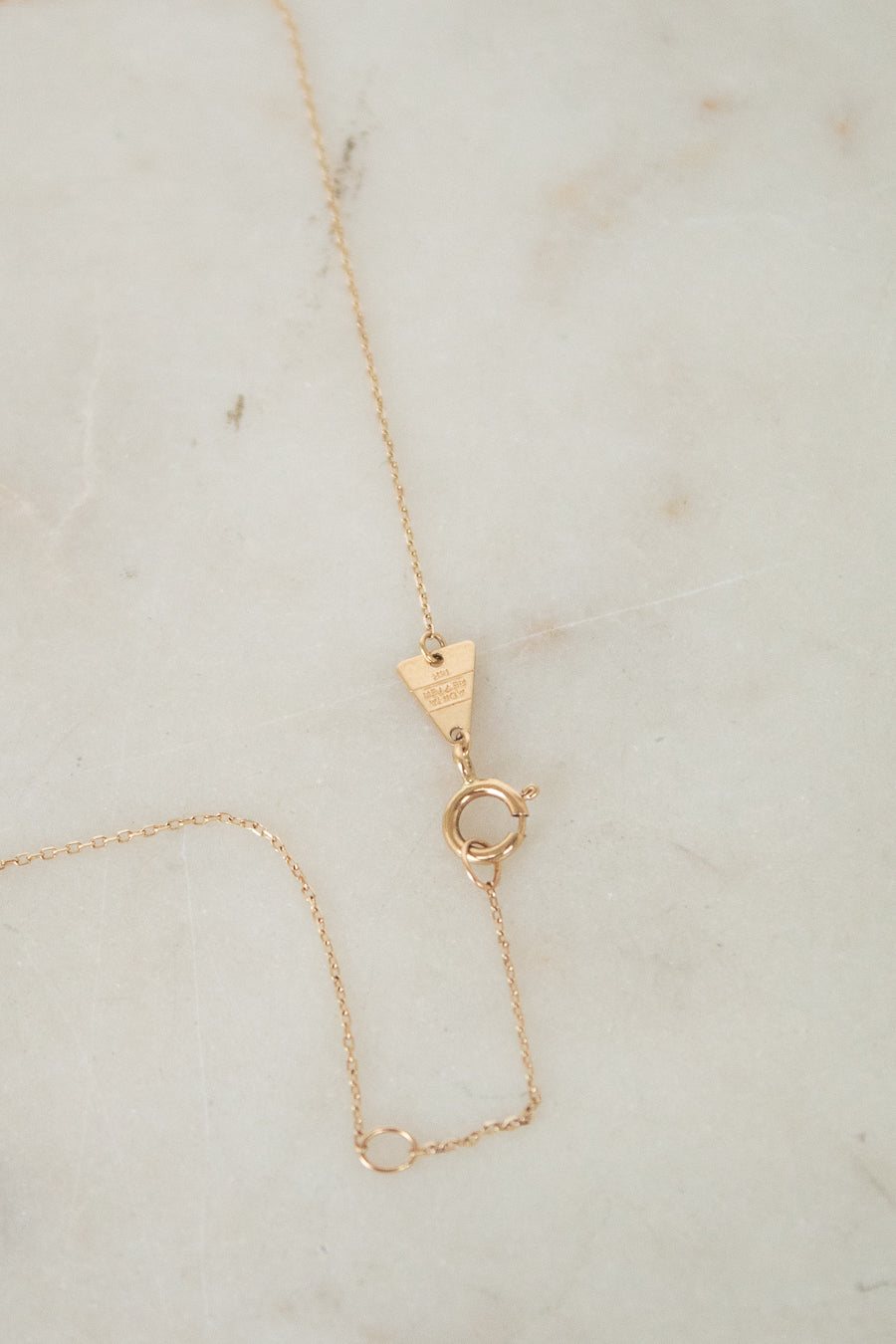 Close-up of gold closure on chain