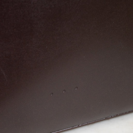 Close-up of a dark brown leather surface on a marble background