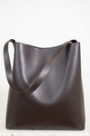 Brown leather tote bag on a white background
