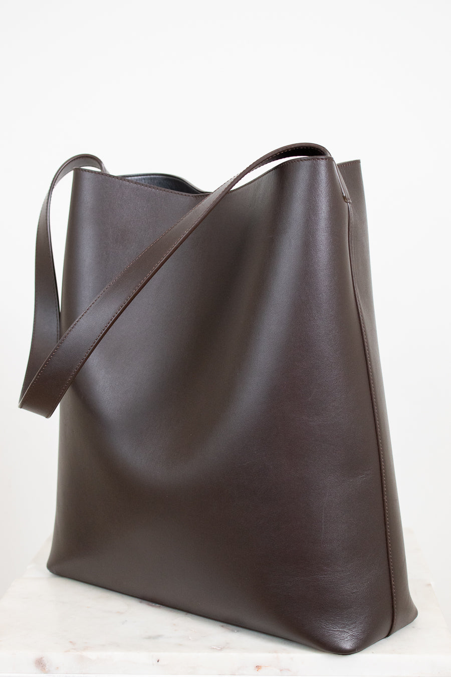 Brown leather tote bag on a white background