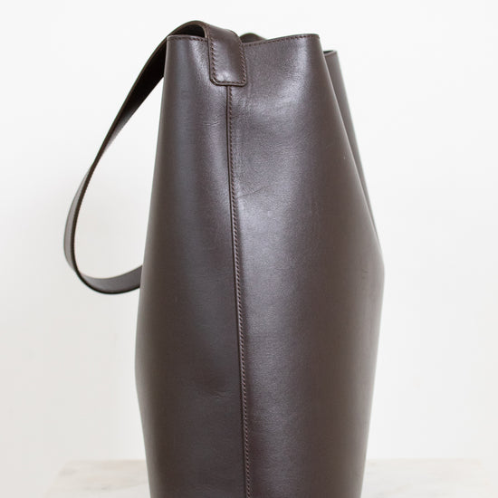 Brown leather tote bag on a white background