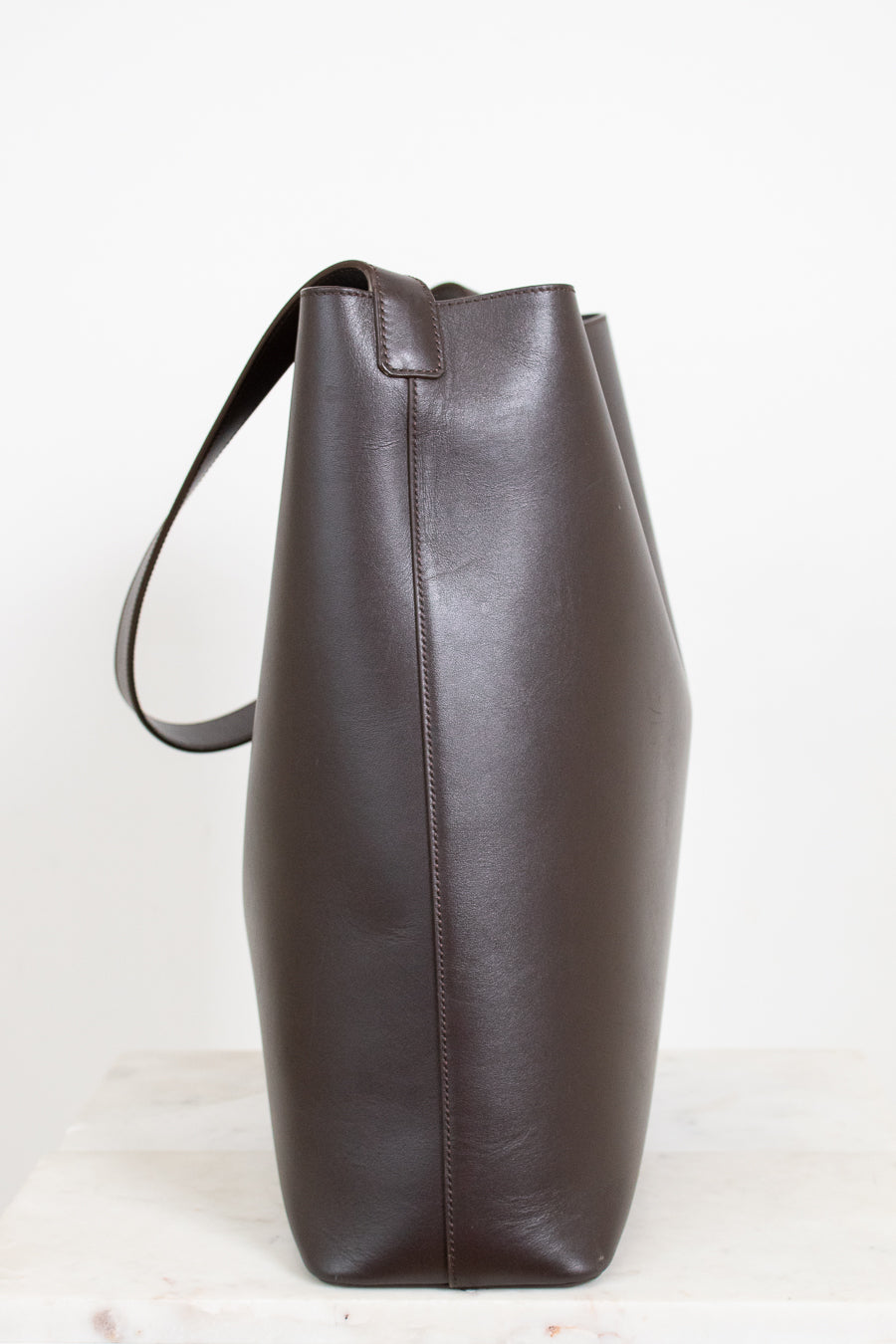 Brown leather tote bag on a white background