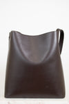 Brown leather shoulder bag on a white background