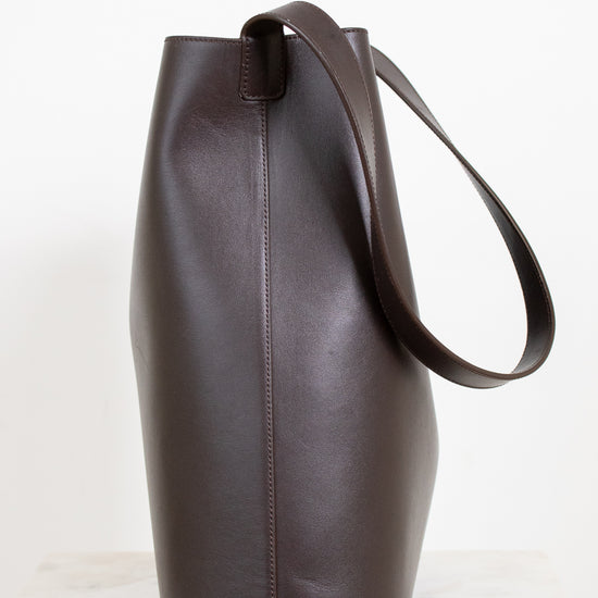 Brown leather tote bag on a white background