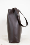 Brown leather tote bag on a white background