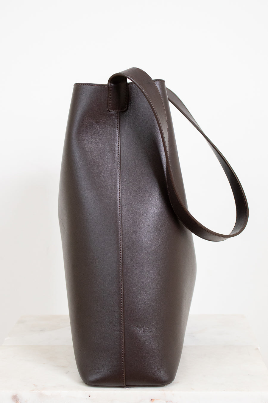 Brown leather tote bag on a white background