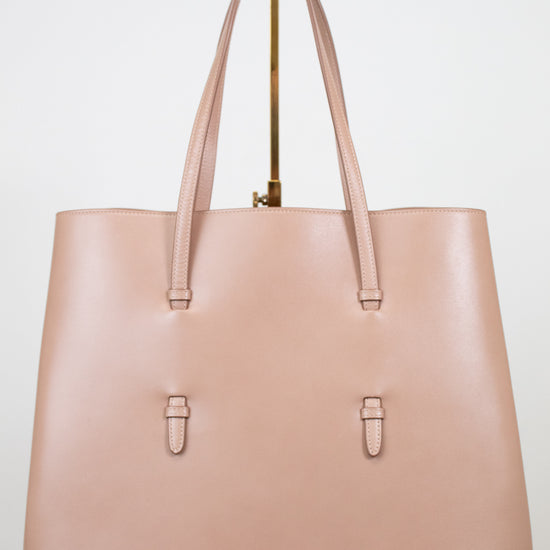 Beige leather tote purse on white background