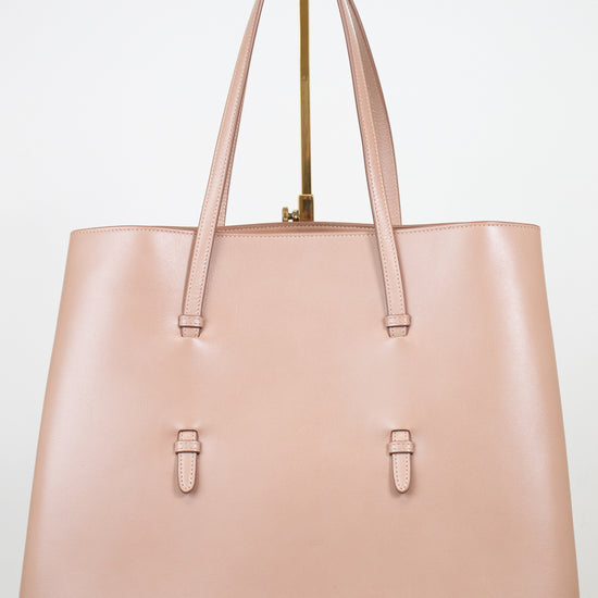 Beige leather tote on white background