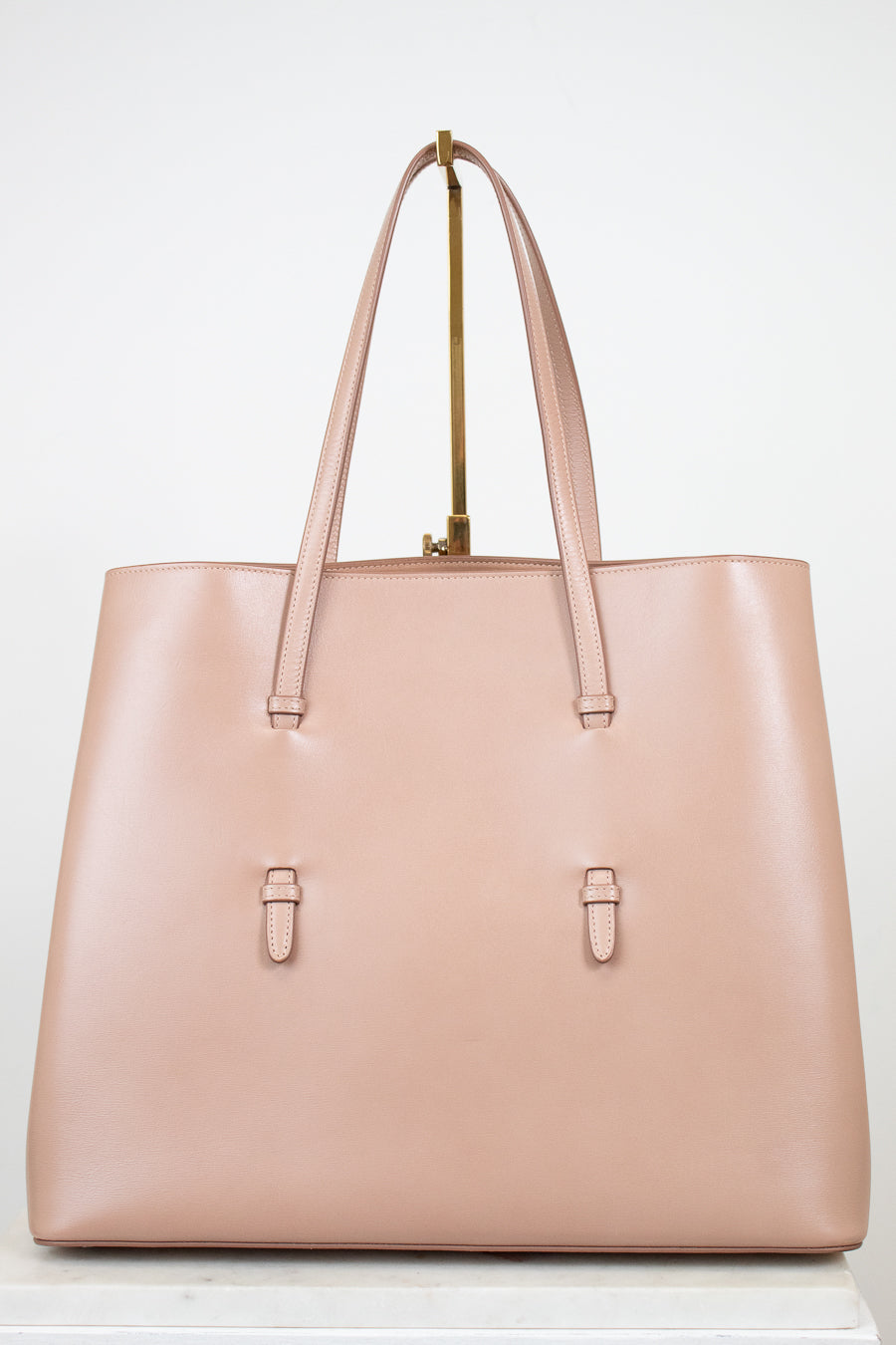 Beige leather tote on white background