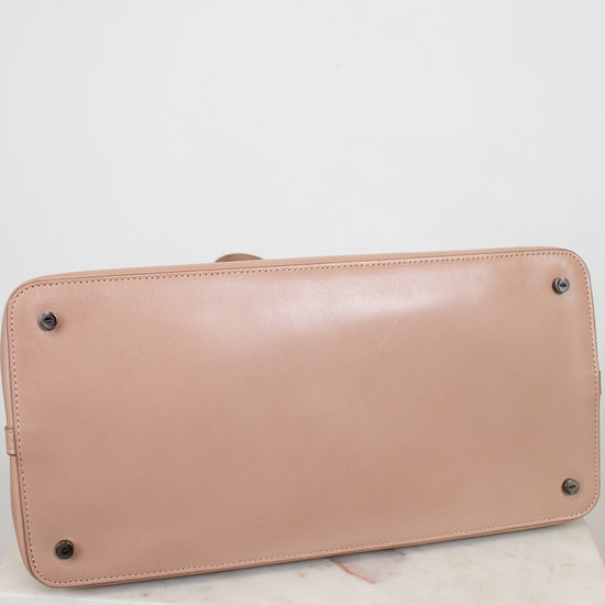 Base of beige handbag on a white background