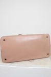 Base of beige handbag on a white background