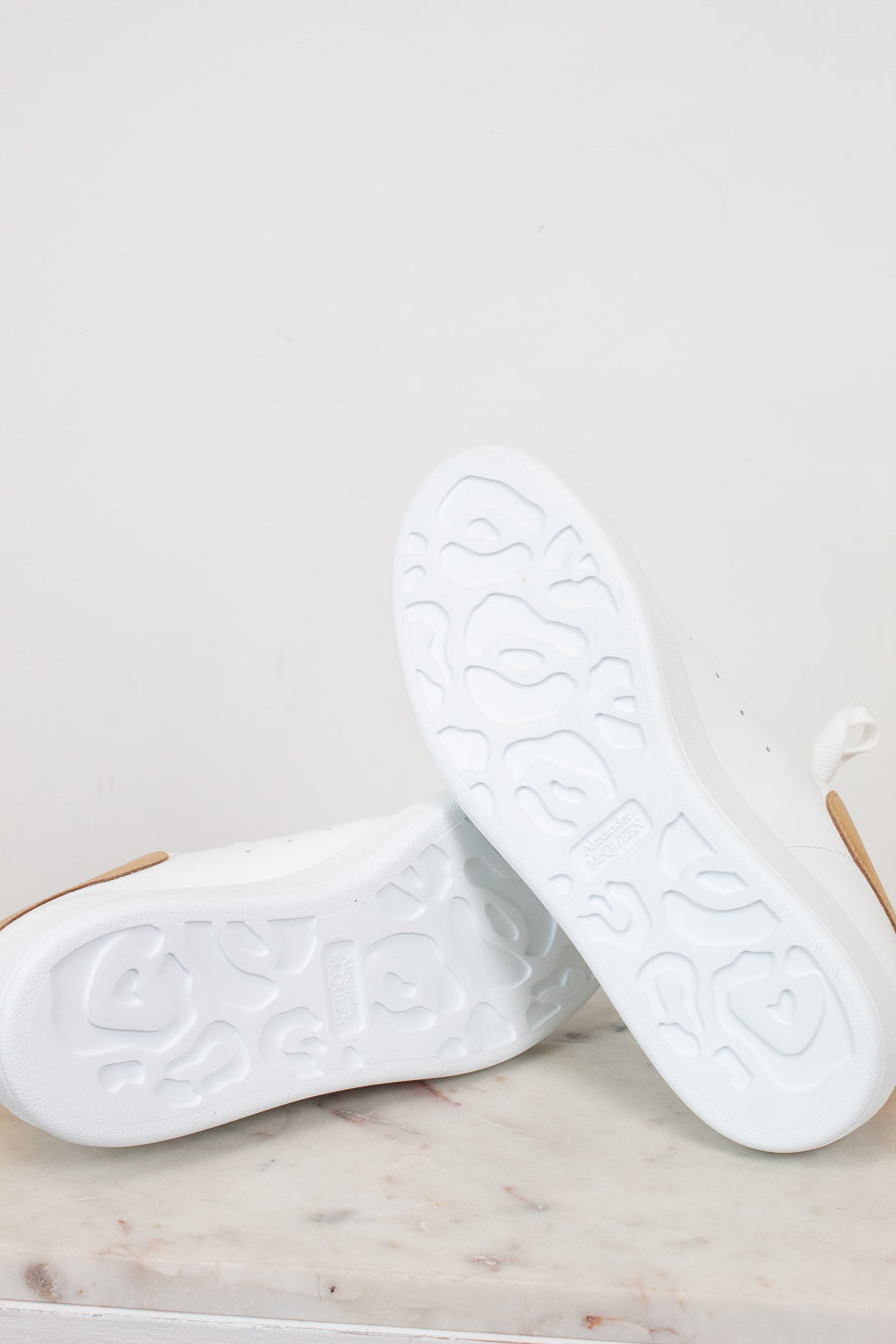 White sneakers on a marble surface