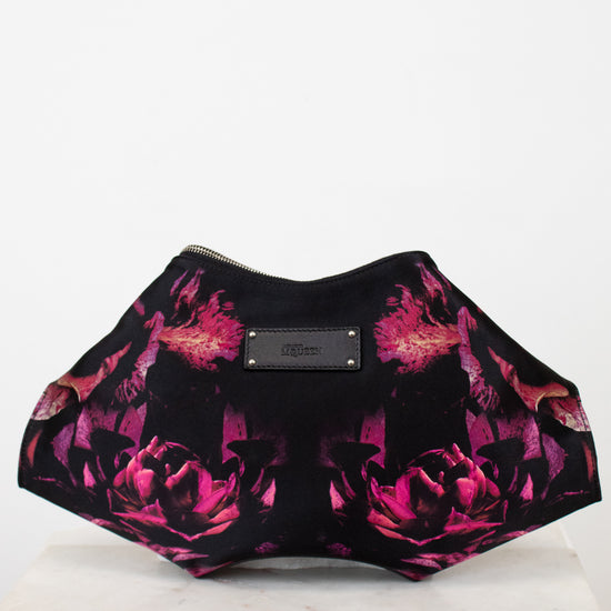 Black and pink floral patterned clutch bag on a white background