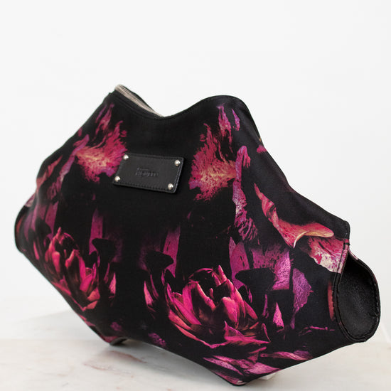 Floral patterned handbag with a brand logo on a white background