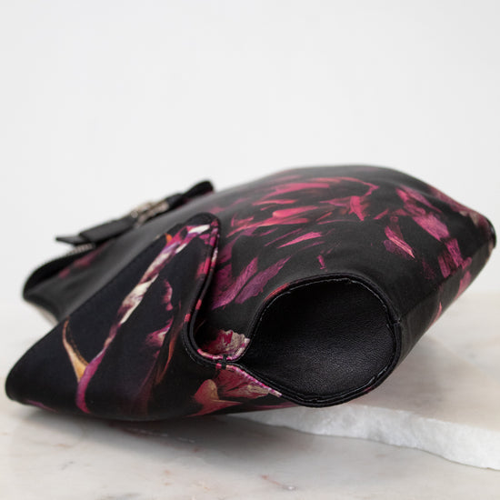 Floral-patterned clutch bag on a marble surface