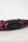 Black and pink patterned bag on a marble surface