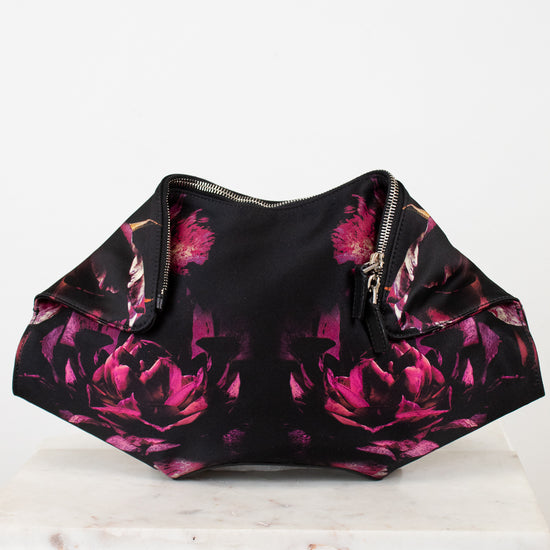Black clutch with pink floral pattern on a white background