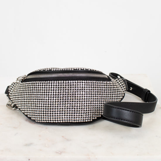 Black and silver studded checkered fanny pack on a light marble surface