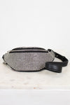 Black and silver studded checkered fanny pack on a light marble surface
