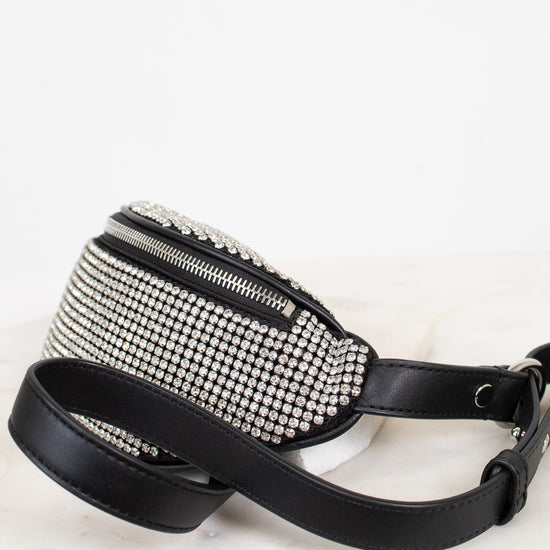 Black studded waist bag with a leather strap on a white background