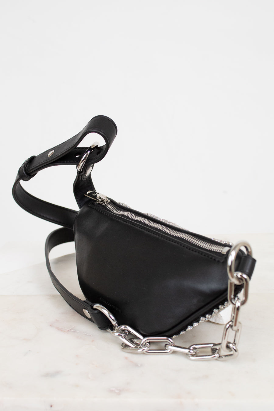 Black handbag with silver chain detail on a white background