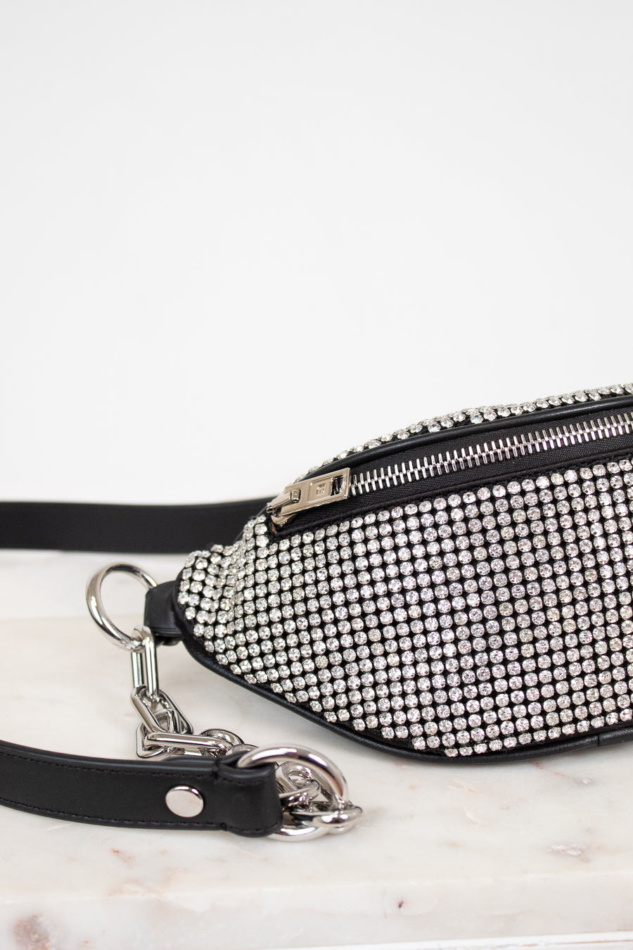 Studded waist bag with black strap on a white background