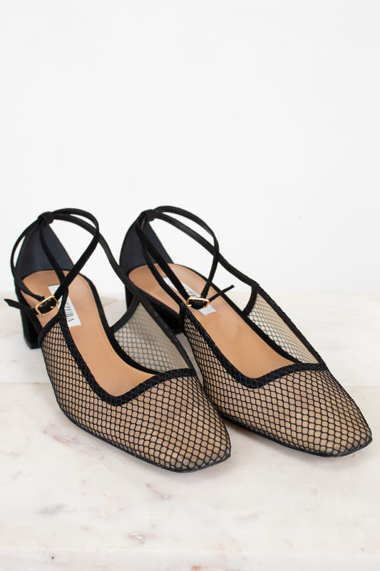 Black mesh shoes on a light background