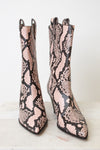 A pair of pointed-toe mid-calf boots featuring a pink and black snakeskin pattern, set against a clean white background.