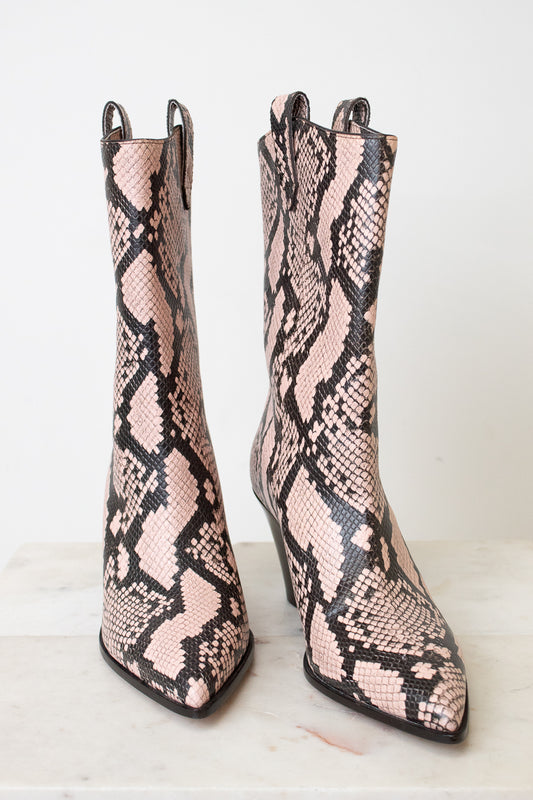 A pair of pointed-toe mid-calf boots featuring a pink and black snakeskin pattern, set against a clean white background.