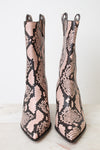 A pair of pointed-toe ankle boots featuring a pink and black snakeskin pattern, displayed against a clean white background.
